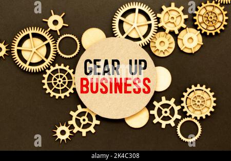 Handwriting text Gear Up Business. Concept meaning tool for assessing needs of idea and create plan Paper clip and torn cardboard placed above a woode Stock Photo