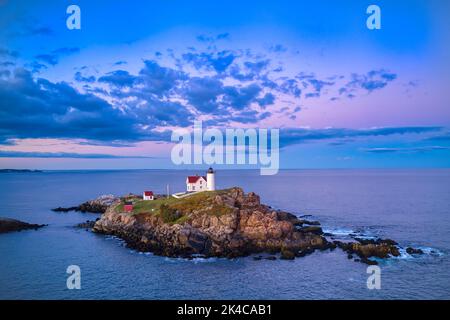 “Nubble Lighthouse and Moon” The Cape Neddick Lighthouse stands on Nubble Island about 100yd off Cape Neddick Point. It is commonly known as Nubble Li Stock Photo