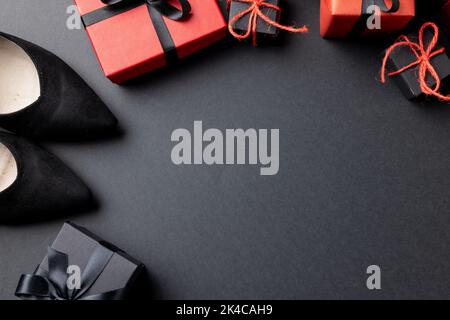 Composition of shoes and presents with copy space on gray background Stock Photo