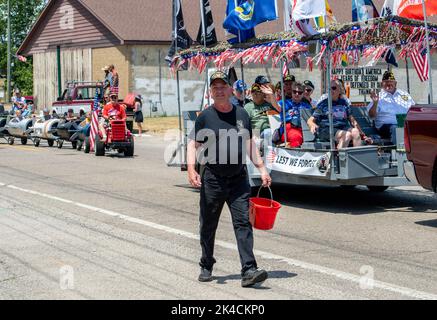 Eau Claire MI USA July 4 2022; some ride on floats, some walk, and even young children participate in this small town parade on the 4th of july Stock Photo