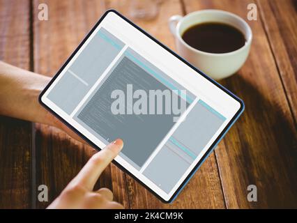 Woman using her tablet pc on wooden table Stock Photo