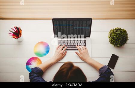 Overhead view of businesswoman using laptop at her desk Stock Photo