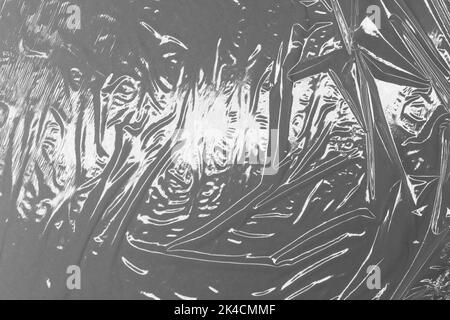 Reflecting light and shadow on creases and folds in plastic sheeting. monochrome light and texture, abstract background image. Stock Photo