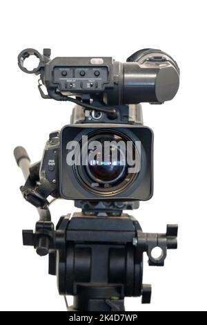 Old studio video camera on tripod, a front view, isolated on white background Stock Photo