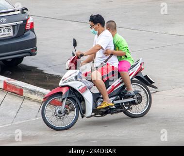 SAMUT PRAKAN, THAILAND, SEP 23 2022, A man rides with boy on a motorcycle. Stock Photo