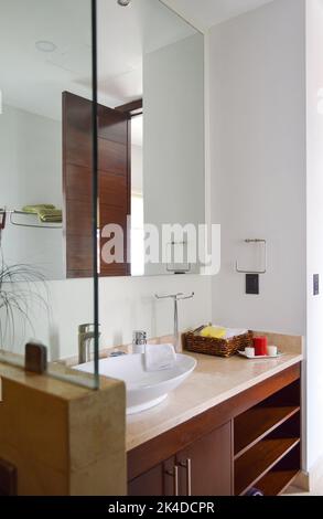 Spacious bathroom in gray tones with heated floors, freestanding tub. Stock Photo