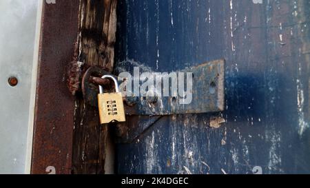 New golden lock in an old rustly latch Stock Photo