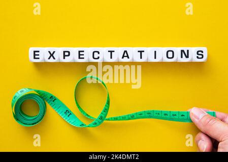 Tape measuring with Expectations word. Stock Photo