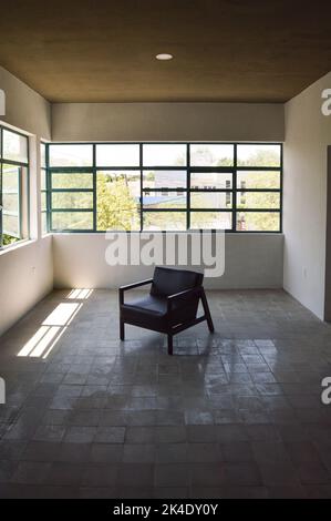 armchair, chair, individual sofa, solid natural wood structure, seat and back in natural leather Stock Photo