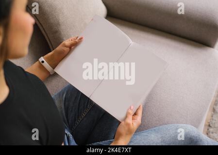 Woman (female) two hands hold an empty blank book spread Stock Photo