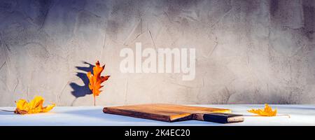 Cutting board with product place or copy space with fallen autumn leaves on it Stock Photo