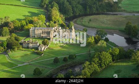 Early morning sunshine illuminates Bolton Abbey in Wharfedale, North Yorkshire, England, takes its name from the ruins of the 12th-century Augustinian Stock Photo