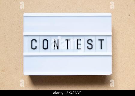 Lightbox with word contest on wood background Stock Photo
