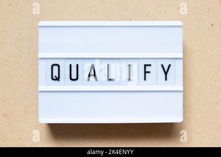 Lightbox with word qualify on wood background Stock Photo