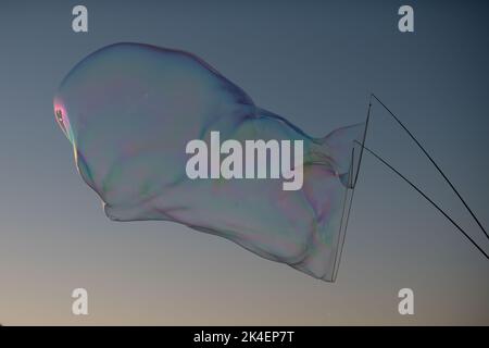The soap bubble floating against the cloudy sunset sky Stock Photo - Alamy