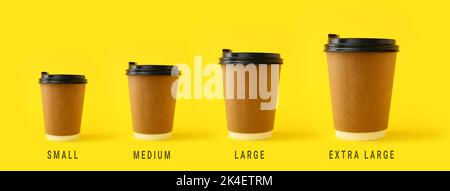 Different sized takeaway coffee cups on yellow background Stock Photo
