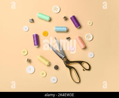 Scissors and sewing supplies on color background Stock Photo
