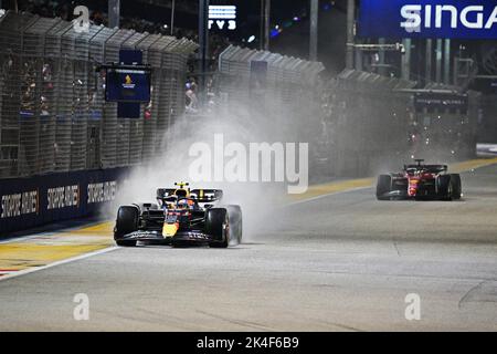 Singapore. 2nd Oct, 2022. Red Bull's Mexican driver Sergio Perez (L) drives during the Formula One Singapore Grand Prix Night Race at the Marina Bay Street Circuit in Singapore on Oct. 2, 2022. Credit: Then Chih Wey/Xinhua/Alamy Live News Stock Photo