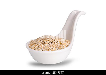 View of dried pearled barley seeds in white ceramic sauce cup isolated on white background with clipping path. Stock Photo