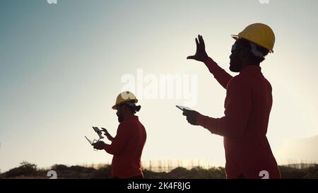 Drone engineers working on construction site - Aerial engineering concept Stock Photo