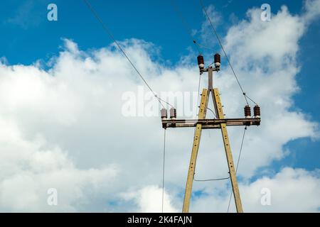 Single concrete electric pole with ceramic insulators and wires Stock Photo