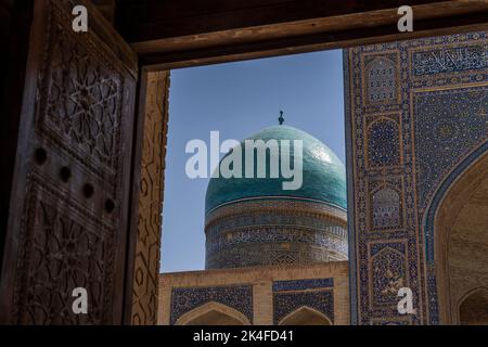 Zoom of Mir-i-Arab madrassa blue-tiled dome from courtyard of Kalan Mosque, Bukhara Old Town Stock Photo