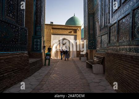 Blue tiled facades and arches of the Shah-i-Zinda mausoleum complex at sunset, Samarkand Stock Photo