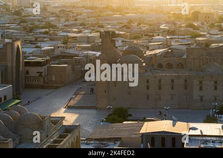 Mosques and Madrasas, historical buildings in Bukhara old town aerial view at sunrise. Stock Photo