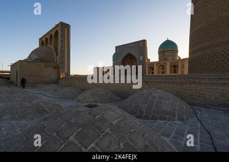 Roof-top vaults of Kalan Mosque and Mir-i-Arab Madrasa, Kalon Minaret Tower, Bukhara Stock Photo
