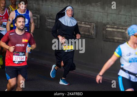 London, UK.  2 October 2022. A costumed runner as a nun near Blackfriars takes part in the TCS London Marathon.  The 42nd event is this year sponsored by Tata Consultancy Services (TCS).  40,000 elite athletes, club runners and fun runners are taking part in the mass event.  In 2023, the race will return to its usual April date in the calendar.  Credit: Stephen Chung / Alamy Live News Stock Photo