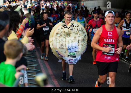 London, UK.  2 October 2022. A costumed runner as a crumpet near Blackfriars takes part in the TCS London Marathon.  The 42nd event is this year sponsored by Tata Consultancy Services (TCS).  40,000 elite athletes, club runners and fun runners are taking part in the mass event.  In 2023, the race will return to its usual April date in the calendar.  Credit: Stephen Chung / Alamy Live News Stock Photo