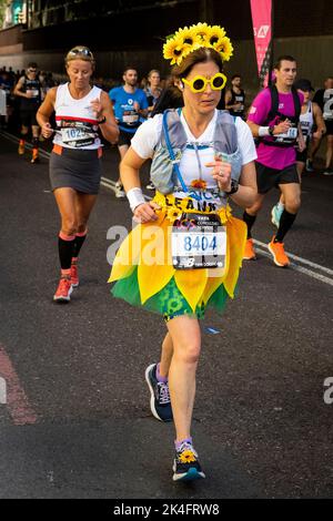 London, UK.  2 October 2022. A costumed runner as a sunflower near Blackfriars take part in the TCS London Marathon.  The 42nd event is this year sponsored by Tata Consultancy Services (TCS).  40,000 elite athletes, club runners and fun runners are taking part in the mass event.  In 2023, the race will return to its usual April date in the calendar.  Credit: Stephen Chung / Alamy Live News Stock Photo