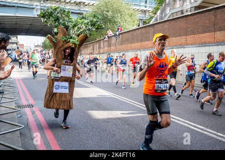 London, UK.  2 October 2022. A costumed runner as a tree near Blackfriars take part in the TCS London Marathon.  The 42nd event is this year sponsored by Tata Consultancy Services (TCS).  40,000 elite athletes, club runners and fun runners are taking part in the mass event.  In 2023, the race will return to its usual April date in the calendar.  Credit: Stephen Chung / Alamy Live News Stock Photo