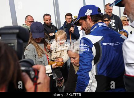 Prince Carl Philip Bernadotte won the second race in Saturday's Porsche Sprint Challenge Scandinavia in the Grande Finale at Mantorp Park, Mantorp, Sweden. To the left his wife princess Sofia holding prince Julian. Stock Photo