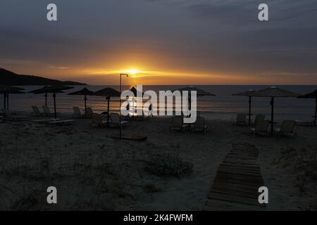 Summer sunrise over Golden Beach (Skala Potamias) in Greece with an overcast sky. Stock Photo