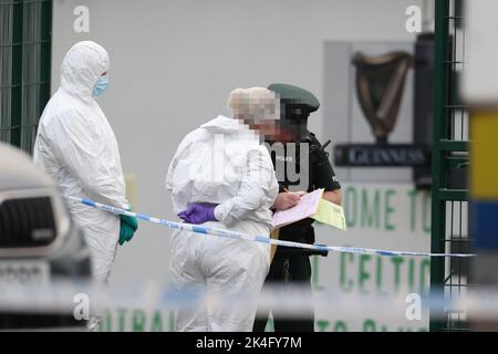 EDITORS NOTE IMAGE PIXELLATED BY THE PA PICTURE DESK FOR THE PROTECTION OF OFFICERS OF THE PSNI Scenes of crime officers from the PSNI at the scene following a shooting at the clubhouse of Donegal Celtic Football Club, in west Belfast. Picture date: Sunday October 2, 2022. Stock Photo