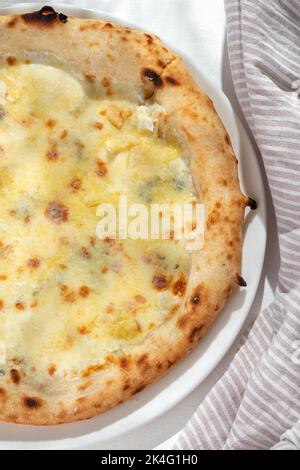 Cinque Formaggi or Five-Cheese Pizza on white background for restaurant menu.Pizza in composition. Italian cuisine. close up Stock Photo