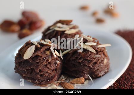 Ragi dates Sheera. Indian pudding made of finger millet flour ghee, milk, dates and dry fruits. Traditionally known as ragi halwa. Classic Indian swee Stock Photo