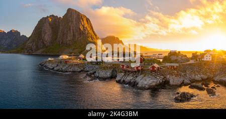 Red wooden huts, known as Rorbu, in the village of Reine on the Hamnoy island, Lofoten Islands, Norway. Rorbu is a Norwegian traditional house used by Stock Photo