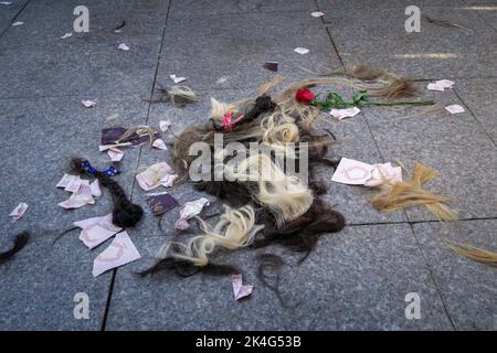 Istanbul, Turkey. October 2, 2022: In response to the arrest of an Iranian woman by the country's morality police in Tehran, the hair on the floor of women cut during the protest demonstration was held in Kadikoy Istanbul, Turkey on October 2, 2022. Mahsa Amini, 22, was visiting Iran's capital, Tehran, with her family on September 13, 2022, when she was detained by the police unit responsible for enforcing strict dress codes, including wearing headscarves, for women in Iran. She was declared dead on September 16, 2022 by state television after being in a coma for three days. Credit: ZUMA Press Stock Photo
