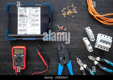 Different electrical tools and digital tablet on wooden background, flat lay. Stock Photo