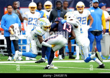 Houston, USA. Houston, Texas, USA. 2nd Oct, 2022. Houston Texans wide receiver Brandin Cooks (13) is tackled by Los Angeles Chargers cornerback Asante Samuel Jr. (26) and safety Nasir Adderley (24) after a catch during the first quarter between the Houston Texans and the Los Angeles Chargers at NRG Stadium in Houston, TX on October 2, 2022. (Credit Image: © Erik Williams/ZUMA Press Wire) Credit: ZUMA Press, Inc./Alamy Live News Stock Photo