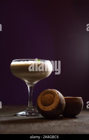 cocktails and coconut dessert on a purple background Stock Photo