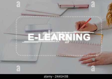 Online study. E-learning technology. Digital marketing. Distance education. Unrecognizable woman student watching virtual lesson taking notes using ta Stock Photo
