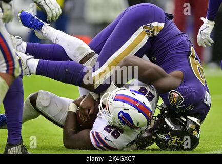 Baltimore, United States. 24th Dec, 2022. The football pops loose from  Atlanta Falcons quarterback Desmond Ridder (4) under pressure from  Baltimore Ravens linebacker Odafe Oweh (L) during the first half at M&T