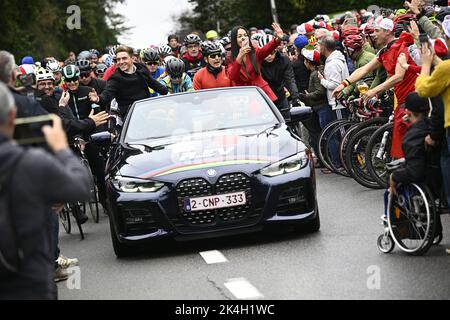 Belgian Remco Evenepoel and his girlfriend Oumi Rayane sit in a convertible car surrounded by bikers for a big bike ride to Brussels around world champion, Sunday 02 October 2022, part of the celebration of world champion Evenepoel, the 22 years old, from Schepdael, Dilbeek, became world champion after a great season with a win at the Vuelta, first Belgian in 44 years to win a big tour. BELGA PHOTO JASPER JACOBS Stock Photo
