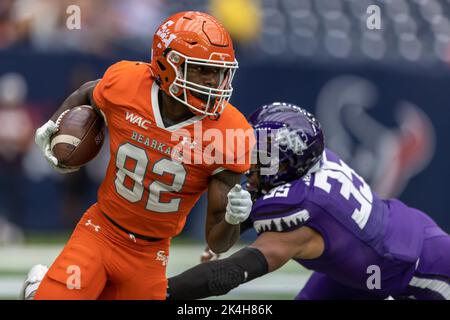 Sam Houston State Bearkats wide receiver Chris Hicks (82) runs after the catch past Stephen F. Austin Lumberjacks linebacker Christian Richards (35), Stock Photo