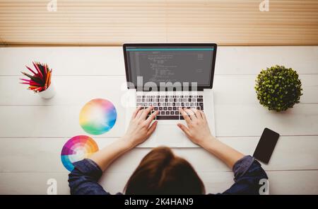 Overhead view of businesswoman using laptop at her desk Stock Photo