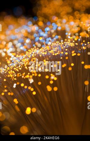 Lit yellow and blue fibre optic strands. Stock Photo
