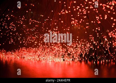 Lit red fibre optic strands. Stock Photo